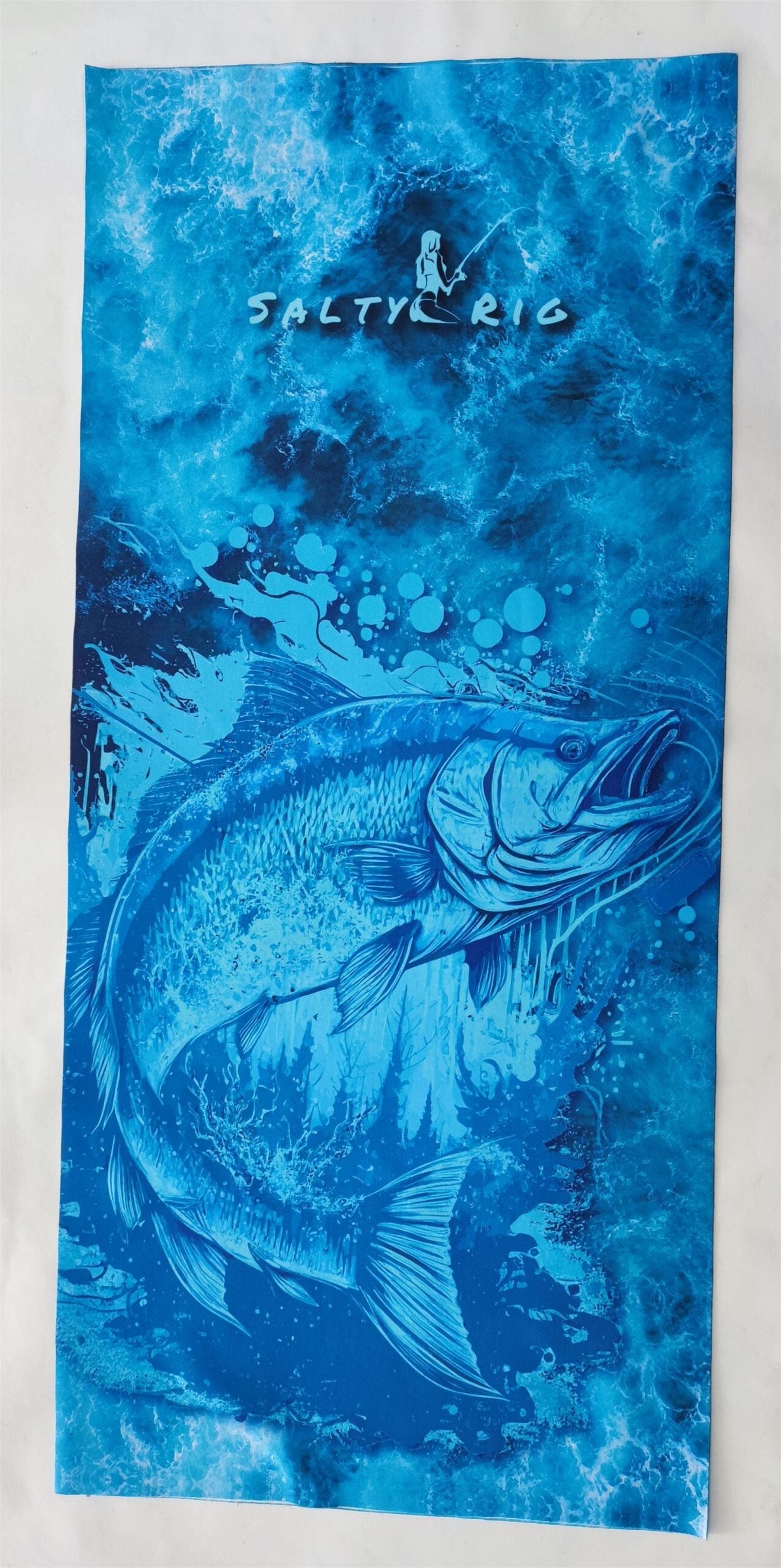 Blue towel with fish design and 'Salty Rig' branding on a white background